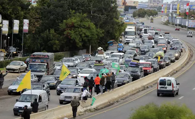 People sit in traffic as they return to their villages after a ceasefire between Israel and Hezbollah went into effect in Ghazieh, Lebanon, Wednesday, Nov. 27, 2024. (AP Photo/Mohammed Zaatari)