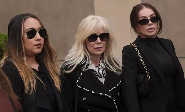Tammi Menendez, center, the wife of Eric Menendez, leaves a courthouse after a hearing in Los Angeles, Monday, Nov. 25, 2024. (AP Photo/Jae C. Hong)
