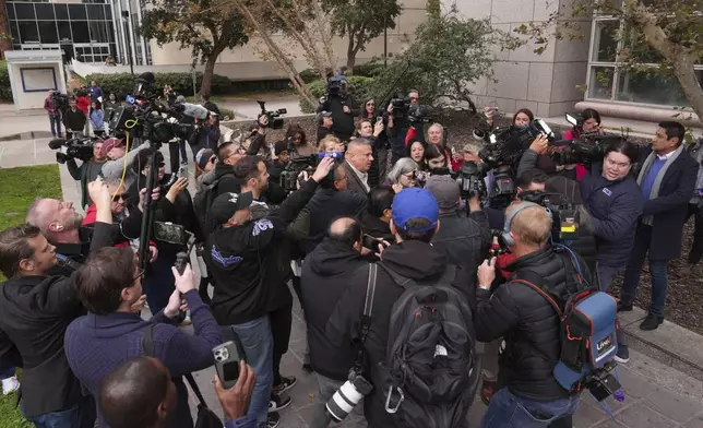 The media surround family members of the Erik and Lyle Menendez brothers as they arrive at a courthouse to attend a hearing in Los Angeles, Monday, Nov. 25, 2024. (AP Photo/Jae C. Hong)