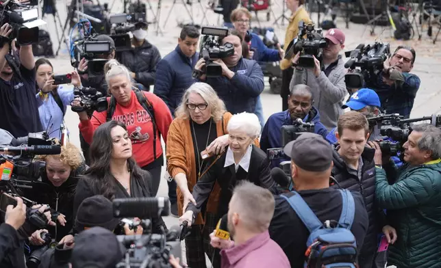 Erik and Lyle Menendez's aunt Joan VanderMolen, center, arrives to attend a hearing at the Van Nuys courthouse in Los Angeles, Monday, Nov. 25, 2024. (AP Photo/Damian Dovarganes)