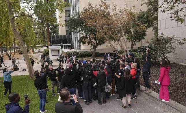The media surround family members of Erik and Lyle Menendez brothers as they arrive at a courthouse to attend a hearing in Los Angeles, Monday, Nov. 25, 2024. (AP Photo/Jae C. Hong)