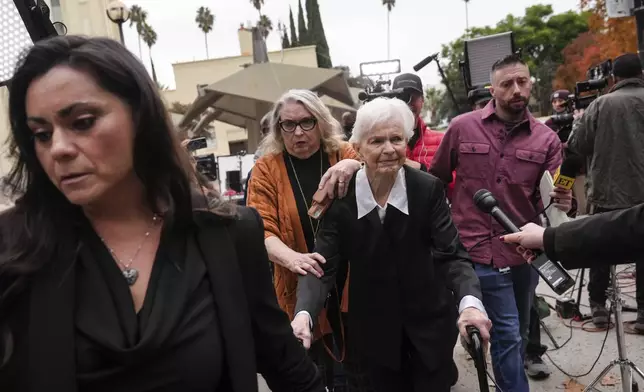 Erik and Lyle Menendez's aunt Joan VanderMolen, center, arrives at a courthouse to attend a hearing in Los Angeles, Monday, Nov. 25, 2024. (AP Photo/Jae C. Hong)