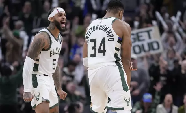 Milwaukee Bucks' Giannis Antetokounmpo celebrates with Gary Trent Jr. during overtime of an NBA basketball game against the Detroit Pistons Wednesday, Nov. 13, 2024, in Milwaukee. (AP Photo/Morry Gash)