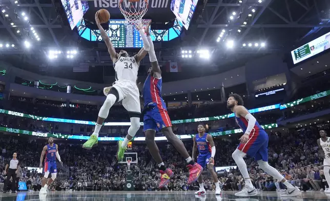 Milwaukee Bucks' Giannis Antetokounmpo shoots past Detroit Pistons' Jalen Duren during the second half of an NBA basketball game Wednesday, Nov. 13, 2024, in Milwaukee. (AP Photo/Morry Gash)