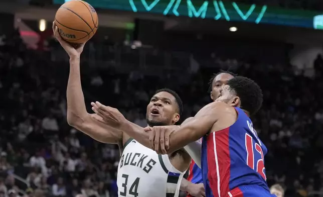 Detroit Pistons' Tobias Harris fouls Milwaukee Bucks' Giannis Antetokounmpo during the second half of an NBA basketball game Wednesday, Nov. 13, 2024, in Milwaukee. (AP Photo/Morry Gash)