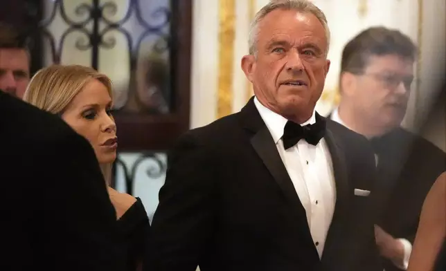 Robert F. Kennedy Jr., and his wife Cheryl Hines arrive before President-elect Donald Trump speaks during an America First Policy Institute gala at his Mar-a-Lago estate, Thursday, Nov. 14, 2024, in Palm Beach, Fla. (AP Photo/Alex Brandon)