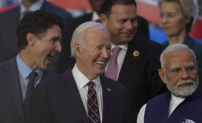 Canada's Prime Minister Justin Trudeau, from left, U.S. President Joe Biden and India's Prime Minister Narendra Modi gather for a G20 Summit world leaders' group photo, in Rio de Janeiro, Tuesday, Nov. 19, 2024. (AP Photo/Silvia Izquierdo)