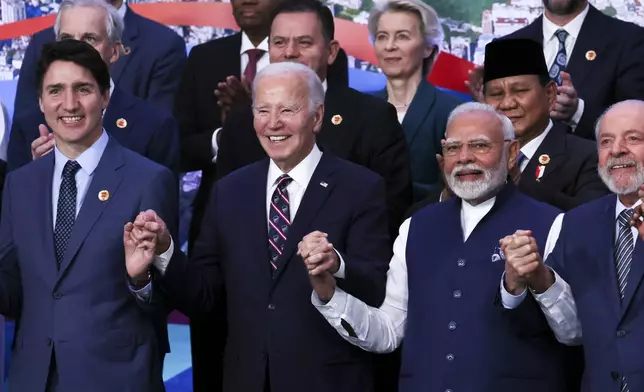 U.S. President Joe Biden, Indian Prime Minister Narendra Modi, Canada's Prime Minister Justin Trudeau and Indian Prime Minister Narendra Modi react, as world leaders gather for a group photo during the G20 summit in Rio de Janeiro, Brazil, Tuesday, Nov. 19, 2024. (Leah Millis via AP, Pool)