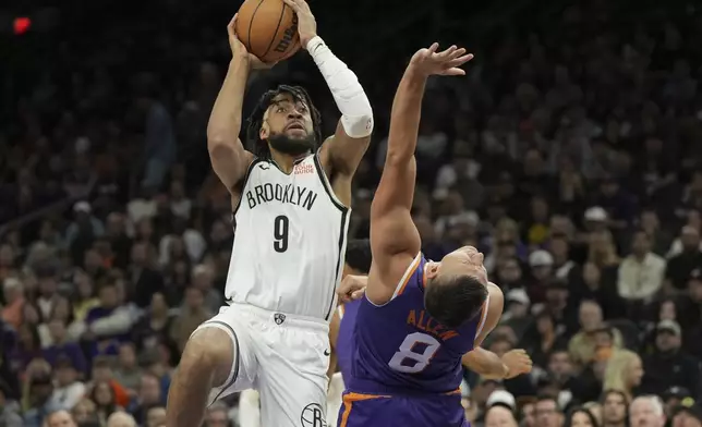 Brooklyn Nets forward Trendon Watford drives on Phoenix Suns guard Grayson Allen (8) during the first half of an NBA basketball game, Wednesday, Nov. 27, 2024, in Phoenix. (AP Photo/Rick Scuteri)