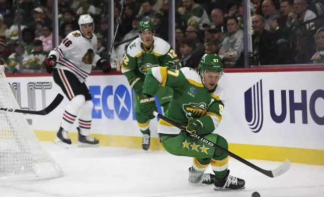 Minnesota Wild left wing Kirill Kaprizov (97) pivots with the puck during the first period of an NHL hockey game against the Minnesota Wild, Friday, Nov. 29, 2024, in St. Paul, Minn. (AP Photo/Ellen Schmidt)