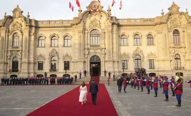 Peru's President Dina Boluarte, left, and Chinese President Xi Jinping walk down the red carpet during a welcome ceremony at the government palace in Lima, Peru, Thursday, Nov. 14, 2024, on the sidelines of the Asia-Pacific Economic Cooperation (APEC) summit. (AP Photo/Fernando Vergara)