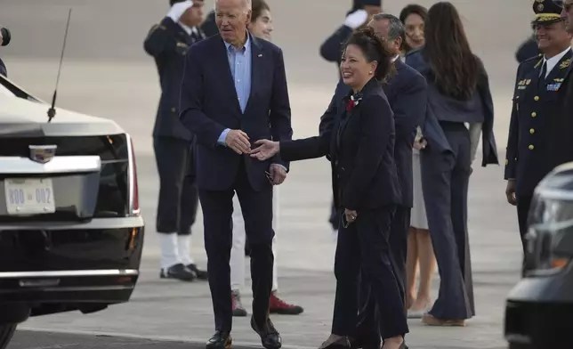 U.S. President Joe Biden, left, shakes hands with US Ambassador to Peru Stephanie Syptak-Ramnath on the airport tarmac ahead of the Asia-Pacific Economic Cooperation (APEC) summit, in Lima, Peru, Thursday, Nov. 14, 2024. (AP Photo/Guadalupe Pardo)