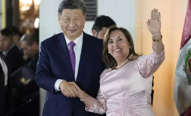 Peru's President Dina Boluarte, right, and Chinese President Xi Jinping shake hands after a ceremony to virtually inaugurate a Chinese-funded port in the city of Chancay, at the government palace in Lima, Peru, Thursday, Nov. 14, 2024. (AP Photo/Fernando Vergara)