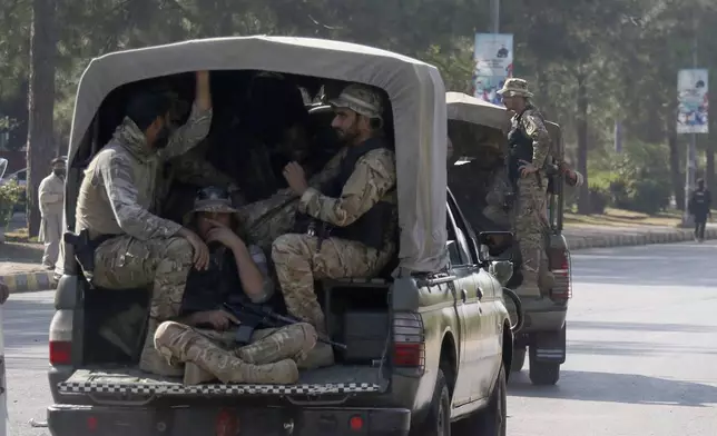 Pakistan's army troops move toward the Red Zone, which is an area that houses key government buildings, to take position ahead of the rally of supporters of imprisoned former premier Imran Khan's Pakistan Tehreek-e-Insaf party, in Islamabad, Pakistan, Tuesday, Nov. 26, 2024. (AP Photo/Ehsan Shahzad)