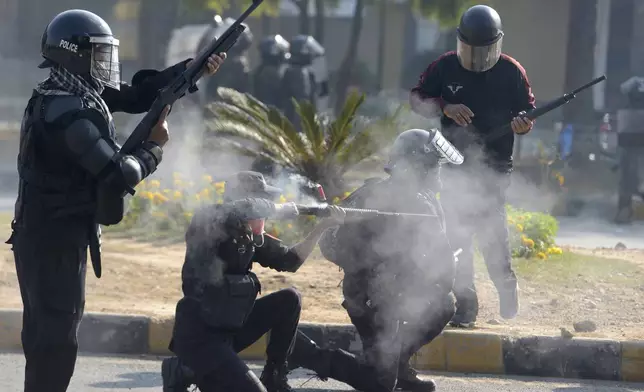 Police officers fire rubber bullets to disperse supporters of imprisoned former premier Imran Khan's Pakistan Tehreek-e-Insaf party, during clashes, in Islamabad, Pakistan, Tuesday, Nov. 26, 2024. (AP Photo/Irtisham Ahmed)