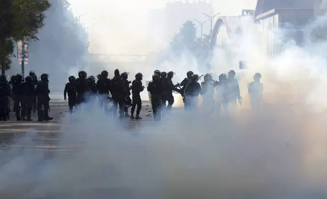 Paramilitary soldiers fire tear gas shells to disperse supporters of imprisoned former premier Imran Khan's Pakistan Tehreek-e-Insaf party, during clashes, in Islamabad, Pakistan, Tuesday, Nov. 26, 2024. (AP Photo/Irtisham Ahmed)