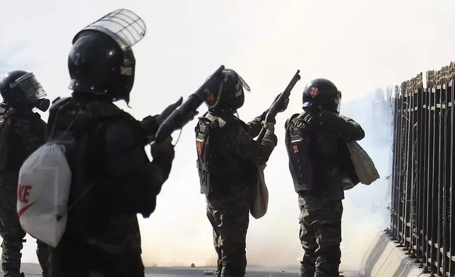 Paramilitary soldiers fire rubber bullets and tear gas shells to disperse supporters of imprisoned former premier Imran Khan's Pakistan Tehreek-e-Insaf party, during clashes at D-Chowk square close to Red Zone in Islamabad, Pakistan, Tuesday, Nov. 26, 2024. (AP Photo/Ehsan Shahzad)