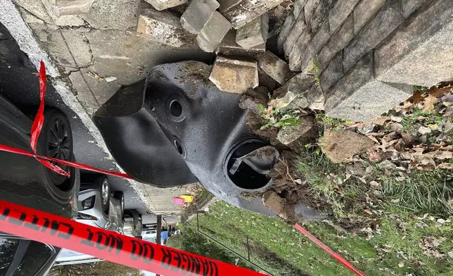 A large metal piece of debris that was flung across a street by a blast at a Louisville, Ky, plant is shown on Wednesday, Nov. 13, 2024. Two workers died in the explosion at the Givaudan Color Sense plant in Louisville. (AP Photo/Dylan Lovan)