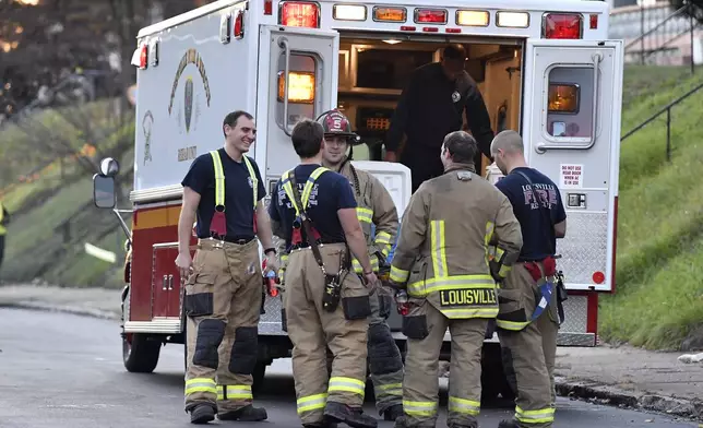 Members of the Louisville Fire Departments check their gear as they prepare to enter Givaudan Sense Colour following an explosion at the facility in Louisville, Ky., Tuesday, Nov. 12, 2024. (AP Photo/Timothy D. Easley)