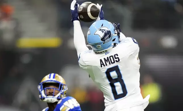 Toronto Argonauts' DaShaun Amos (8) makes an interception against the Winnipeg Blue Bombers during the second half of a CFL football game at the 111th Grey Cup in Vancouver, British Columbia, Sunday, Nov. 17, 2024. (Frank Gunn/The Canadian Press via AP)