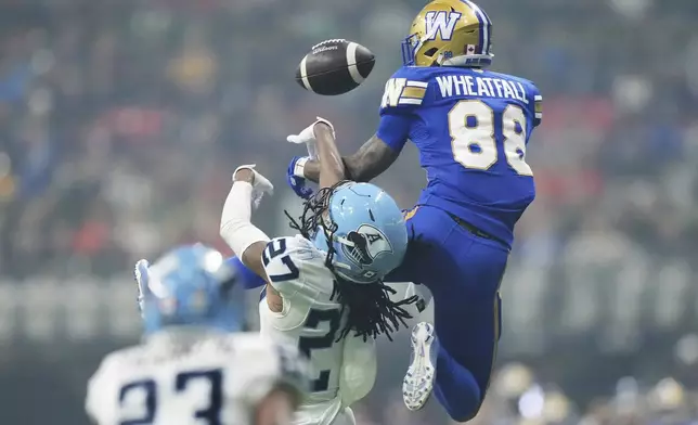 Winnipeg Blue Bombers' Keric Wheatfall (88) can't make the catch as Toronto Argonauts' Mark Milton (27) defends during the second half of a CFL football game at the 111th Grey Cup in Vancouver, British Columbia, Sunday, Nov. 17, 2024. (Nathan Denette/The Canadian Press via AP)