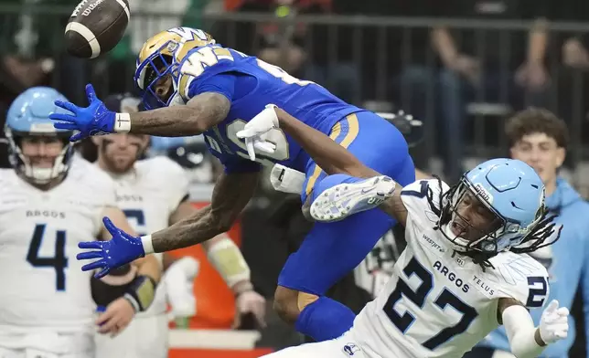 Winnipeg Blue Bombers' Keric Wheatfall (88) can't make the catch as Toronto Argonauts' Mark Milton (27) defends during the second half of a CFL football game at the 111th Grey Cup in Vancouver, British Columbia, Sunday, Nov. 17, 2024. (Frank Gunn/The Canadian Press via AP)