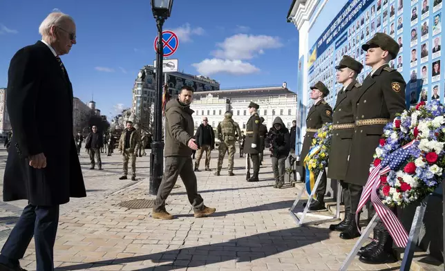 FILE - US President Joe Biden, left, participates in a wreath laying ceremony with Ukrainian President Volodymyr Zelenskyy at the memorial wall outside of St. Michael's Golden-Domed Cathedral during an unannounced visit, in Kyiv, Ukraine, Monday, Feb. 20, 2023. (AP Photo/Evan Vucci, File)