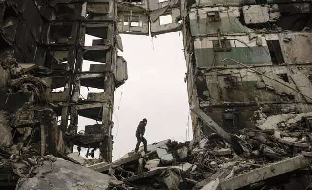 FILE - A resident looks for belongings in an apartment building destroyed during fighting between Ukrainian and Russian forces in Borodyanka, Ukraine, Tuesday, April 5, 2022. (AP Photo/Vadim Ghirda, File)