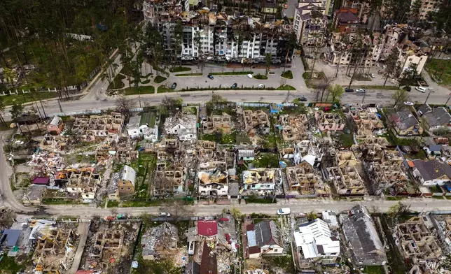 FILE - Destroyed houses are photographed in Irpin, on the outskirts of Kyiv, Ukraine, Saturday, April 30, 2022. (AP Photo/Emilio Morenatti, File)