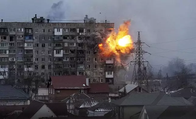 FILE - An explosion is seen in an apartment building after Russian's army tank fires in Mariupol, Ukraine, Friday, March 11, 2022. (AP Photo/Evgeniy Maloletka, File)