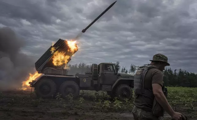 FILE - Ukrainian forces shoot toward Russian positions at the front line in Kharkiv region, Ukraine, on Tuesday, Aug. 2, 2022. (AP Photo/Evgeniy Maloletka, File)