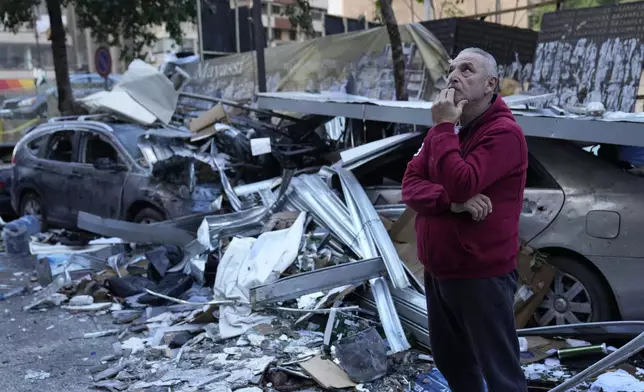 A man watches the damage at the site where an Israeli airstrike Sunday evening hit in central Beirut, Lebanon, Monday, Nov. 18, 2024. (AP Photo/Hussein Malla)