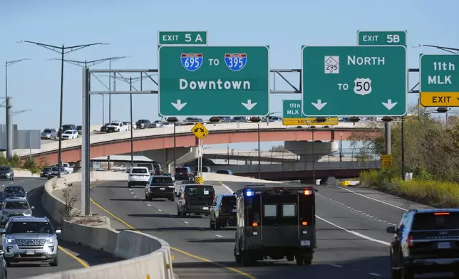 President-elect Donald Trump's motorcade drives through downtown Washington, as he travels to a meeting with the House GOP conference, Wednesday, Nov. 13, 2024, in Washington. (AP Photo/Alex Brandon)