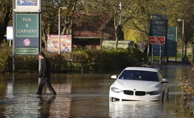 A stranded car in flood water at the Billing Aquadrome as Storm Bert continues to cause disruption, in Northampton, England, Monday, Nov. 25, 2024. (Jordan Pettitt/PA via AP)