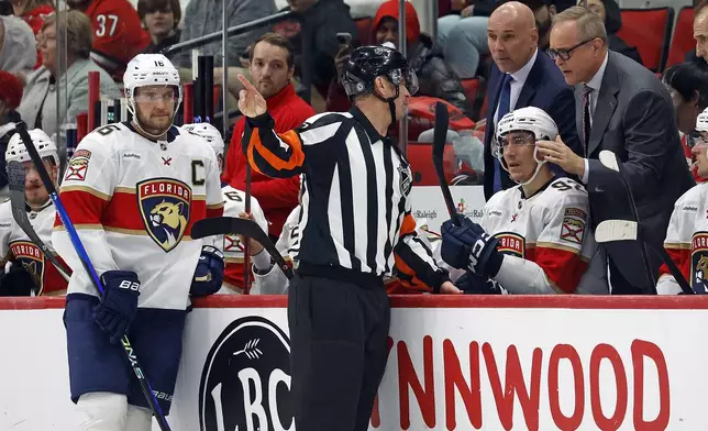 Florida Panthers head coach Paul Maurice gets an explanation from an official during the first period of an NHL hockey game against the Carolina Hurricanes in Raleigh, N.C., Friday, Nov. 29, 2024. (AP Photo/Karl B DeBlaker)