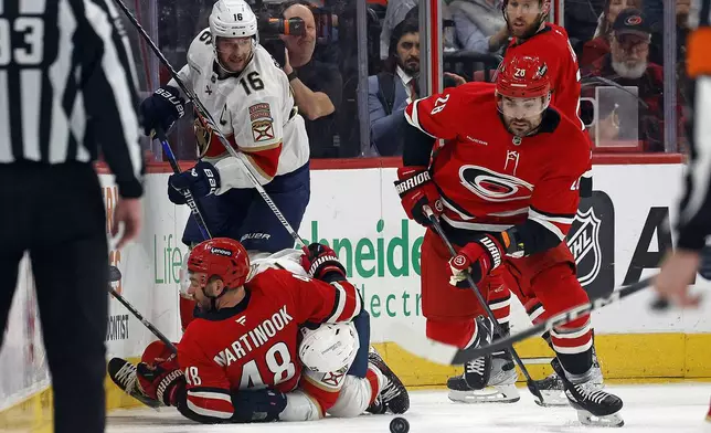 Carolina Hurricanes' William Carrier (28) gathers in the puck against the Florida Panthers during the second period of an NHL hockey game in Raleigh, N.C., Friday, Nov. 29, 2024. (AP Photo/Karl B DeBlaker)