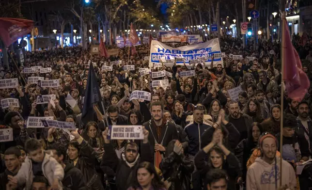 Demonstrators march to protest the skyrocketing cost of renting an apartment in Barcelona, Spain, Saturday, Nov. 23, 2024. (AP Photo/Emilio Morenatti)