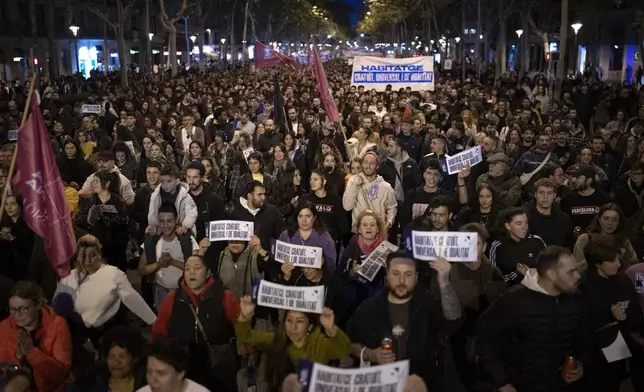 Demonstrators march to protest the skyrocketing cost of renting an apartment in Barcelona, Spain, Saturday, Nov. 23, 2024. (AP Photo/Emilio Morenatti)