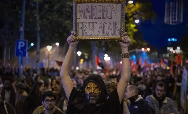 Demonstrators march to protest the skyrocketing cost of renting an apartment in Barcelona, Spain, Saturday, Nov. 23, 2024. (AP Photo/Emilio Morenatti)