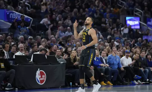 Golden State Warriors guard Stephen Curry reacts after making a 3-point basket during the first half of an Emirates NBA Cup basketball game against the Memphis Grizzlies, Friday, Nov. 15, 2024, in San Francisco. (AP Photo/Godofredo A. Vásquez)