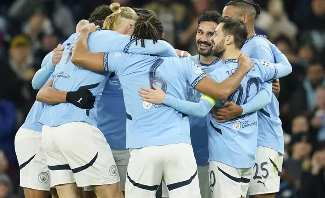 Manchester City's Ilkay Gundogan, third right, celebrates after scoring his side's second goal during the Champions League opening phase soccer match between Manchester City and Feyenoord at the Etihad Stadium in Manchester, England, Tuesday, Nov. 26, 2024. (AP Photo/Dave Thompson)