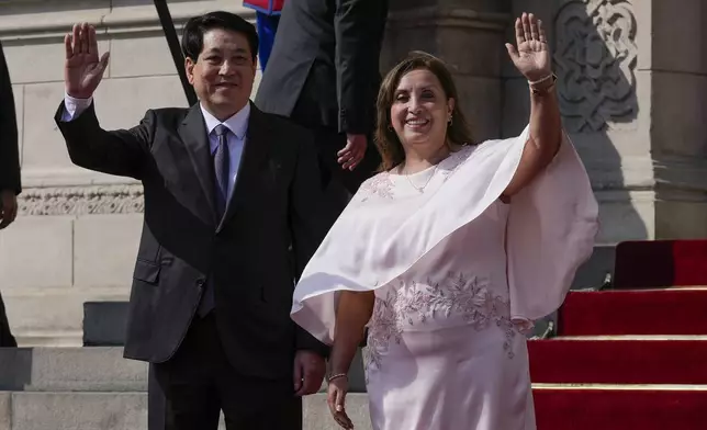 Vietnam's President Luong Cuong, left, and Peru's President Dina Boluarte pose for photos on the steps of the government palace in Lima, Peru, Wednesday, Nov. 13, 2024, during the Asia-Pacific Economic Cooperation (APEC) summit. (AP Photo/Martin Mejia)