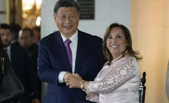 Peru's President Dina Boluarte, right, and Chinese President Xi Jinping shake hands after a ceremony to virtually inaugurate a Chinese-funded port in the city of Chancay, at the government palace in Lima, Peru, Thursday, Nov. 14, 2024. (AP Photo/Fernando Vergara)