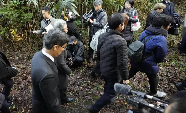 South Korean Ambassador to Japan Park Cheol-hee, left, walks with the relatives of Korean victims and South Korean officials to hold a memorial service at the site of former Fourth Souai Dormitory for the mine workers from the Korean Peninsula, in Sado, Niigata prefecture, Japan, Monday, Nov. 25, 2024, after boycotting a memorial organized by Japanese officials. (AP Photo/Eugene Hoshiko)