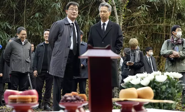 South Korean Ambassador to Japan Park Cheol-hee, front left, looks at a memorial service at the site of former Fourth Souai Dormitory for the mine workers from the Korean Peninsula, in Sado, Niigata prefecture, Japan, Monday, Nov. 25, 2024. (AP Photo/Eugene Hoshiko)