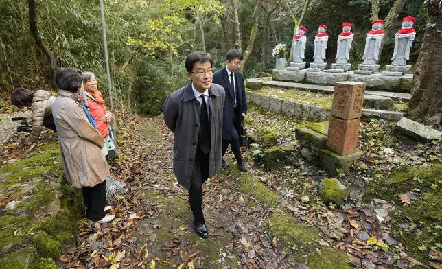 South Korean Ambassador to Japan Park Cheol-hee, center, arrives to join the relatives of Korean victims and South Korean officials to hold a memorial service in Sado, Niigata prefecture, Japan, Monday, Nov. 25, 2024. (AP Photo/Eugene Hoshiko)