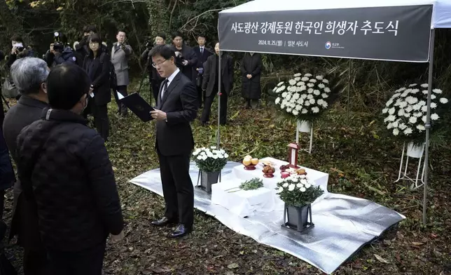 South Korean Ambassador to Japan Park Cheol-hee, center, delivers a speech as relatives of Korean victims and South Korean officials hold a memorial service in Sado, Niigata prefecture, Japan, Monday, Nov. 25, 2024. (AP Photo/Eugene Hoshiko)