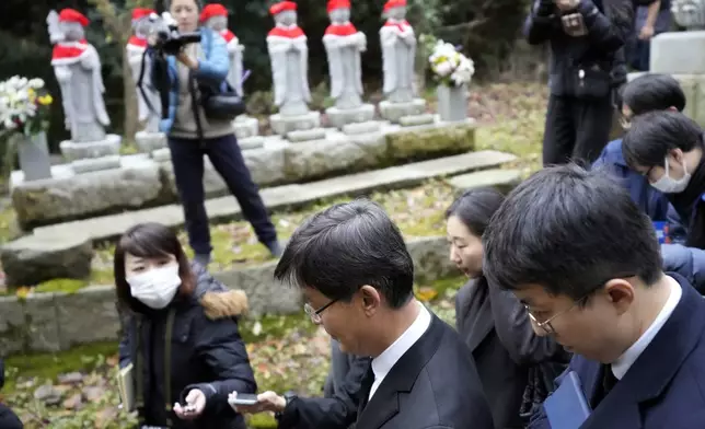 South Korean Ambassador to Japan Park Cheol-hee, bottom left, leaves after a memorial service with the relatives of Korean victims and South Korean officials at the site of former Fourth Souai Dormitory for the mine workers from the Korean Peninsula, in Sado, Niigata prefecture, Japan, Monday, Nov. 25, 2024, a day after boycotting a memorial organized by Japanese officials. (AP Photo/Eugene Hoshiko)