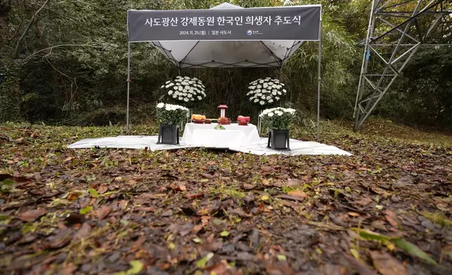 The venue of a memorial service for relatives of Korean victims and South Korean officials is seen in Sado, Niigata prefecture, Japan, Monday, Nov. 25, 2024, after boycotting a memorial organized by Japanese officials. The black banner reads "A memorial service for Korean forced laborer victims at Sado Mine." (AP Photo/Eugene Hoshiko)