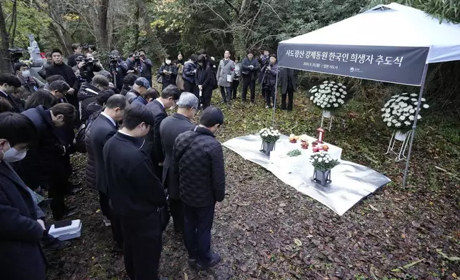 Relatives of Korean victims and South Korean officials offer a minute of silence during a memorial service in Sado, Niigata prefecture, Japan, Monday, Nov. 25, 2024, a day after boycotting a memorial organized by Japanese officials. (AP Photo/Eugene Hoshiko)